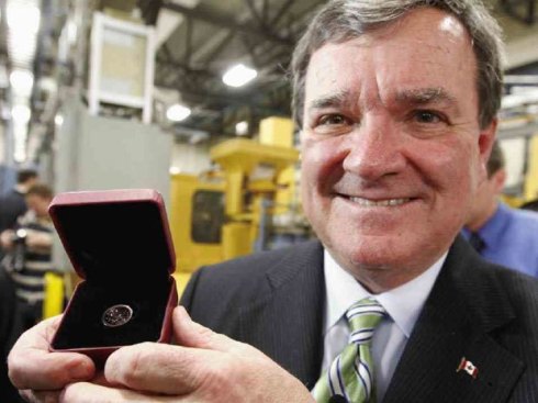 Finance Minister Jim Flaherty shows the last penny produced in Canada. (Keep an eye on Ebay).